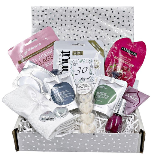 3oth brthday Gift box with various items including skincare products and a nail polish. Face towel, handmade wax melts, tea, foot treatment, gift box and card.