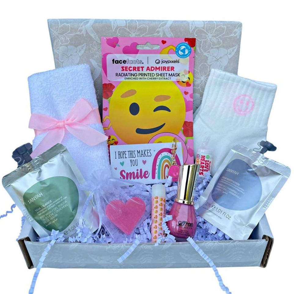Gift box with various items including a face mask, lip balm, and other small products for beauty.