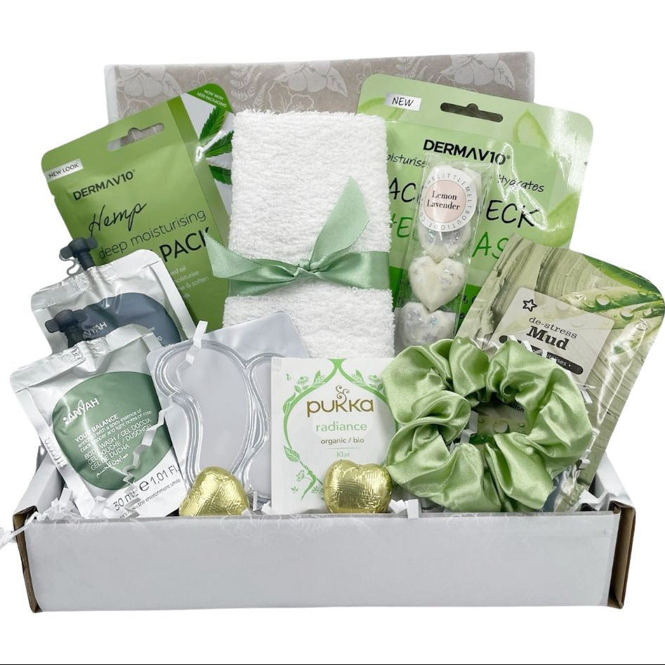 Gift box with skincare products and accessories including a gift card. Face sheet mask, face towel, soap, green tea, chocolates, satin hair scrunchie, very affordable. Available in green Blue and pink.